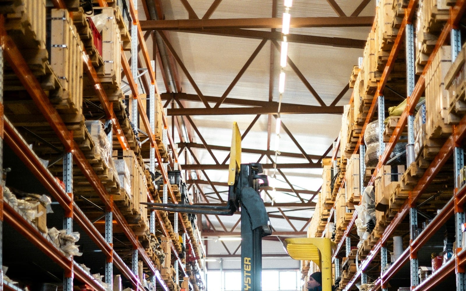 Forklift moving stock in a large warehouse, a typical host environment for labour hire placements