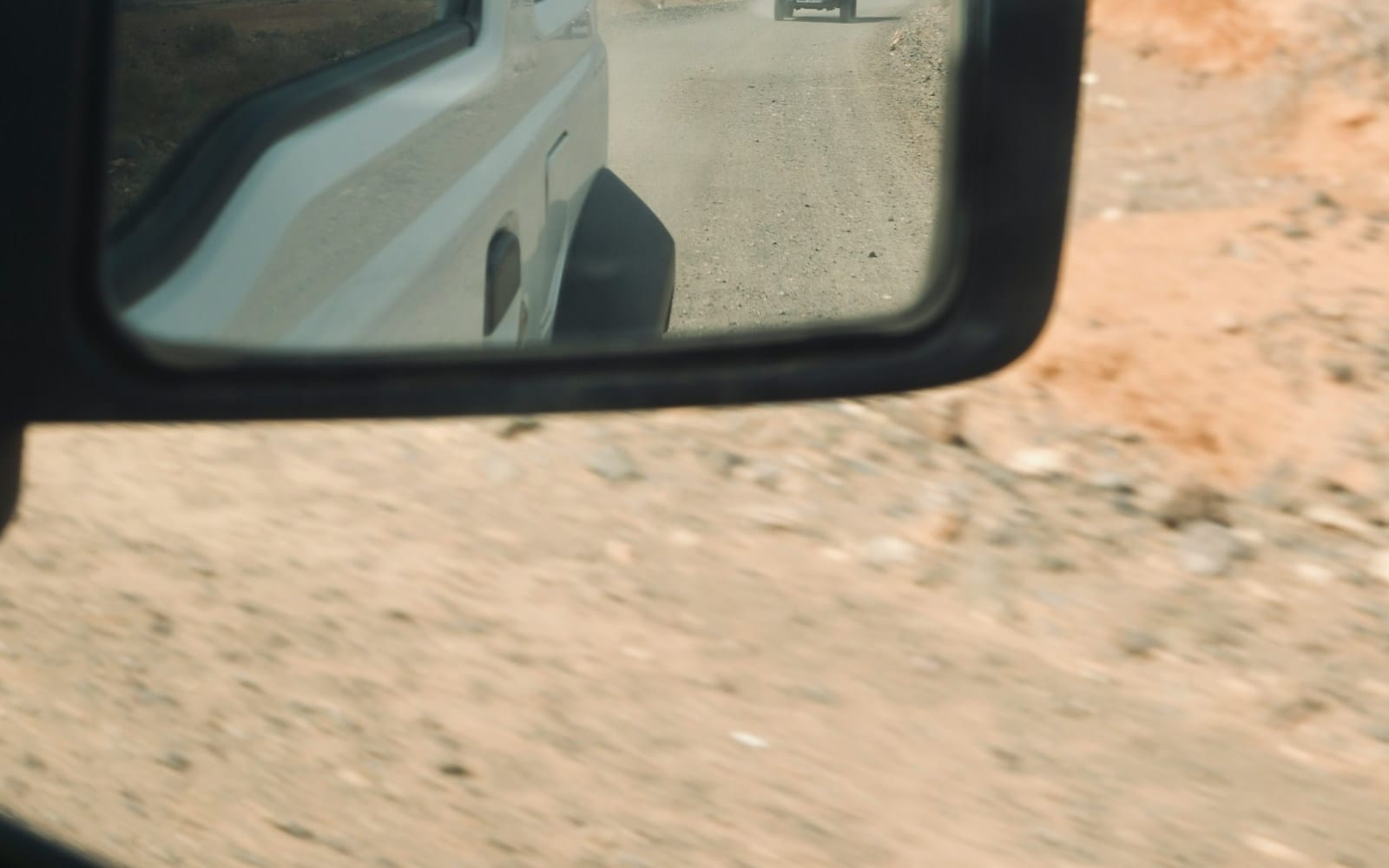 Crew vehicles on a dusty access road, mobilisation day for a remote Australian site