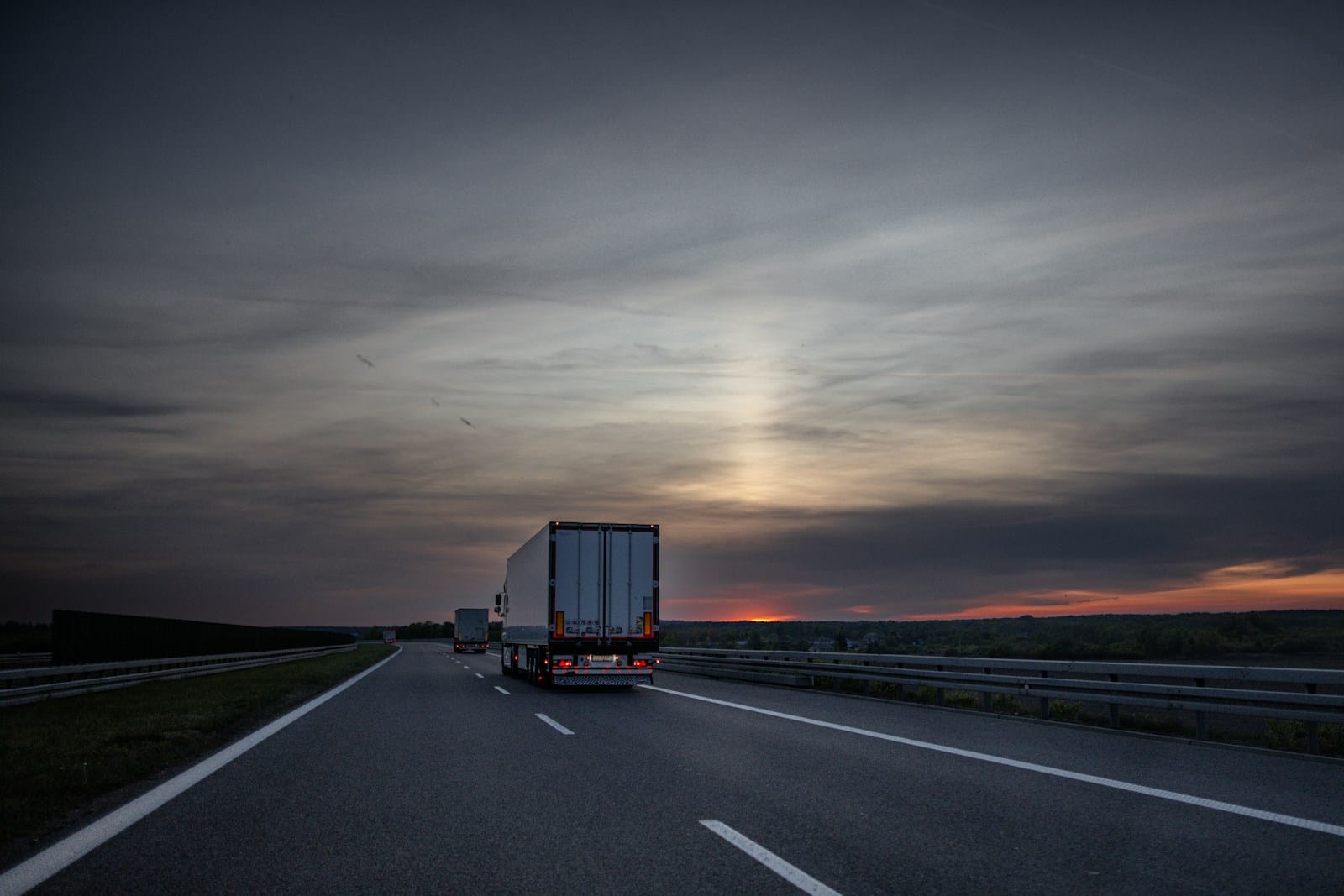 Linehaul trucks on an Australian highway at sunset with hours counted and rest windows protected